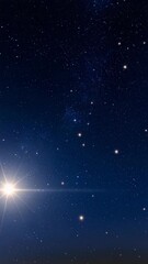 Wall Mural - Bright star shines in a vivid dark blue night sky filled with numerous smaller stars, creating a beautiful cosmic scene.