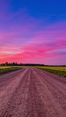 Wall Mural - Vibrant sunset over rural road with dramatic sky in timelapse