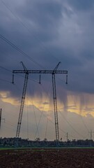Wall Mural - Dramatic skyline with power lines during changing weather in timelapse