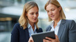 © Kateryna - Female business professionals with digital tablet reviewing data and collaborating on new strategies and ideas in modern office | tablet collaboration data review business