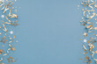 © juliasudnitskaya - Christmas, New Year or birthday festive blue border background top view. Celebration composition with golden confetti stars and serpentine party streamers.