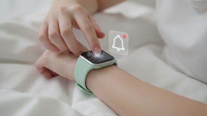 Woman checking smartwatch with glowing alert bell icon in soft light, message alert, digital communication