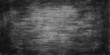 © DAKU MOHARAJ - Old vintage black chalkboard with a rough, textured grunge surface provides a dark blank backdrop