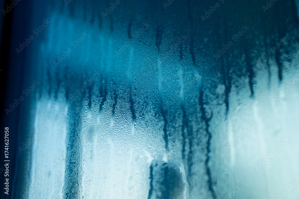 Humid Glass Close-up of fogged glass with water condensation and blue reflections ...