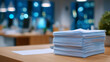 © Maksym - Close-up of neatly stacked patient care documents on a medical office desk, soft ambient lighting highlighting paper texture and edges