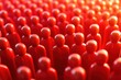 © Molly P - Crowd of Red Figurines Against a Warm Soft Focus Background