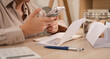 © Garun Studios - Close-up of person scanning receipts with smartphone at desk, showing financial documents, accounting records, and expense tracking for budget planning, reimbursement, and digital bookkeeping.