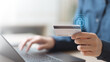 © Garun Studios - Close-up of hand holding credit card with digital lock icon, symbolizing secure online payment, fraud prevention, and financial protection in modern fintech transactions.