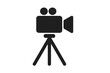 © Lukas - Video camera icon with tripod silhouette. Classic movie camera vector illustration with two reels, tripod stand, and lens. Cinema, filming, recording equipment symbol.