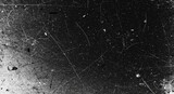 Dirty urban black and white grunge texture with vintage noise. Distressed old photo background featuring dust, smudges, scratches, hairs, and film grain effects.
