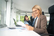 © Nenad - Business team of professional executives working together in office.