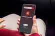 © fadfebrian - A woman visit a website indicates malware, phishing or deceptive practices on her smartphone. Dangerous site warning on smartphone.