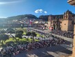 © Alan - A imagem mostra a Plaza de Armas de Cusco, repleta de pessoas reunidas para um evento festivo sob um céu azul intenso. Ao fundo, destaca-se a imponente Catedral de Cusco, construída em pedra no estilo