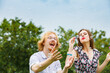 © Voyagerix - Couple blowing soap bubbles, having fun