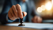 © Kateryna - Document approval and verification: Business hand holding rubber stamp for document authentication corporate executive approving legal papers official stamp validation notary
