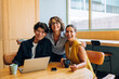 © (JLco) Julia Amaral - Three colleagues smiling in an office setting with relaxed and happy expressions
