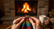 © Aslihan - Closeup of hands knitting a colorful scarf in front of a cozy fireplace with a cup of coffee, creating a warm and relaxing atmosphere at home