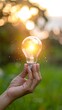 © Bintang - Hand holding glowing lightbulb