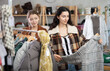 © JackF - Two young women choosing outerwear for autumn and winter in clothing store