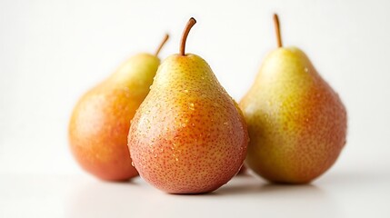 Wall Mural - Three Fresh Red and Yellow Pears with Stems on a White Background, Covered in Water Droplets