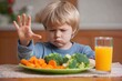 © VolumeThings - A boy declines vegetables and juice expressing unhappiness highlighting parents challenge in encouraging healthy eating in children