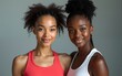 © li - portrait of two women of different skin colors & ethnicity in sports clothing with serious confident face expression. High quality