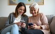 © car - Mature two women smiling and using cellphones while sitting on sofa. High quality