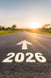 © Faceless - Road with a white arrow pointing up and the number 2026 written below it