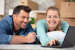 © auremar - beautiful young couple using laptop in their new home