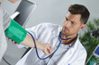 © auremar - male doctor checking patients blood pressure