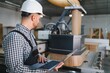 © Serhii - Worker operating cnc machine in furniture factory