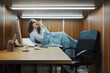© StockPhotoPro - Stressed frustrated woman sleeping and working in a small office