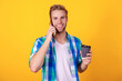 © be free - Man speak on phone at coffee break isolated on yellow. Millennial man has phone call. Man talk on cellphone. Phone call. Mobile connection. Guy with coffee. Student lifestyle. Modern communication