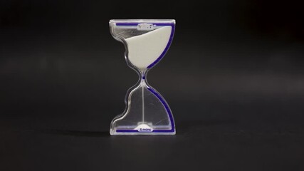 Wall Mural - transparent hourglass on dark background for efficiency and planning