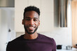 © Westend61 - Smiling man standing in modern home kitchen looking at camera