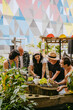 © Westend61 - People engaging in urban gardening in a colorful community garden.