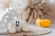 © Юлия Клюева - Autumn decor for Halloween. Cute ghost, white houses, and pumpkins. Banner, background for Halloween celebrations.
