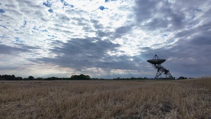 Wall Mural - Observatory under moving clouds in expansive rural landscape