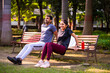 © StockImageFactory - Indian beautiful young couple tricep dips together outdoors in sunny park for fitness goals