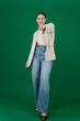 © Oleksandra - Professional photo collection of young European woman in light blazer with hair tied in ponytail and blue jeans on green chroma key background expressing different emotions and gestures perfect for ad