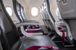 © yaqui_villegas - Airplane cabin interior with empty seats and window light, illustrating modern air travel comfort and minimalist design for business and transportation themes