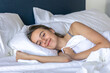 © puhimec - Girl waking with a gentle smile in white bed. Quiet morning.