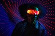© VISTA by Westend61 - Person dancing in neon light with VR set at a modern nightclub