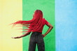 © VISTA by Westend61 - Woman with red braids posing playfully against colorful wall outdoors