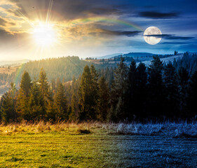 Wall Mural - rural area in mountains on autumn equinox. day and night time change concept. wonderful highland with sun and moon at twilight observed from the hillside. meadows on rolling hills near spruce forest