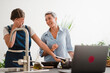© Studio Marmellata - Smiling mature woman looking at young daughter while failing in cooking spending time together at home