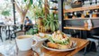© gendis - Delicious Avocado Toast with Coffee on Wooden Table in Cozy Cafe