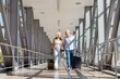 © Anastasiya - Mature couple walking together at airport with luggage, smiling at each other
