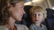 © fotogurme - A curious exchange unfolds between a Caucasian mother and son aboard a plane, embodying World Tourism Day wonder
