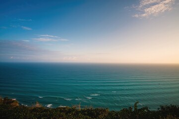 Wall Mural - Sunrise light brightening a scenic sea panorama